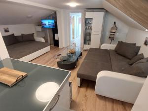 a living room with a couch and a table at Apartment Garden-2 by Interhome in Karl