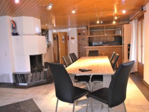 a dining room with a table and chairs and a fireplace at Apartment Calanques by Interhome in Adelboden