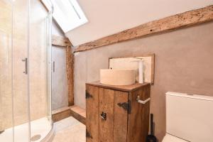 a bathroom with a shower and a toilet at Hastings Old town Cottage style in Hastings