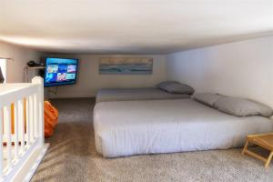 a bedroom with two beds and a flat screen tv at H - Crab Shack in Fort Bragg