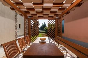 a wooden table on the porch of a house at APP Sandro with Common Pool in Poreč