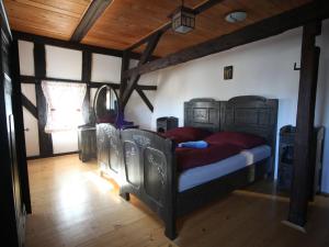 a bedroom with a bed in a room with wooden ceilings at Holiday Home Mezná u Hřenska by Interhome in Mezná