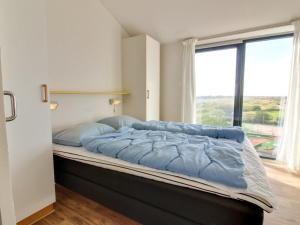 Postel nebo postele na pokoji v ubytování Apartment Huldrik - 100m from the sea in Western Jutland by Interhome