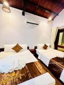 Postel nebo postele na pokoji v ubytování The Poplar Resort Phú Quốc