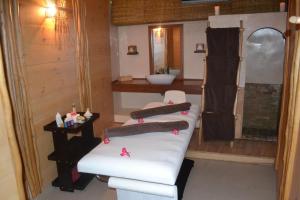 a bathroom with a white couch and a sink at Movenpick Resort Lamantin Saly in Saly Portudal