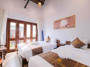Postel nebo postele na pokoji v ubytování The Poplar Resort Phú Quốc