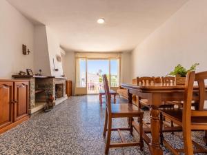 a dining room with a table and chairs and a fireplace at Holiday Home Oleg by Interhome in Torredembarra