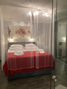 a bedroom with a bed with a red blanket at Apartments Nora & Lucija in Baška +39 photos