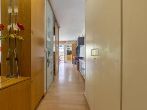 a hallway leading to a kitchen with wood floors and a hallway sidx sidx at Studio Alboran by Interhome in Salou