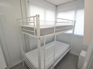 a white bunk bed in a room with a window at Apartment Mare Nostrum by Interhome in Salou