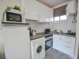 a kitchen with a washing machine and a washer at Apartment Mare Nostrum by Interhome in Salou