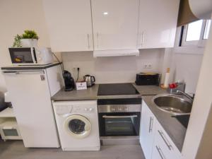 a small kitchen with a sink and a washing machine at Apartment Mare Nostrum by Interhome in Salou