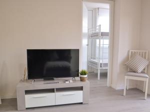 a living room with a flat screen tv on a table at Apartment Mare Nostrum by Interhome in Salou +20 photos