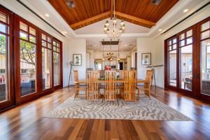 a dining room with a table and chairs at Rainbow Hale Estate in Kahana