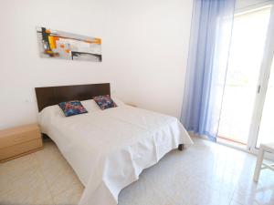 a bedroom with a white bed with two pillows on it at Villa Villa Mallorca by Interhome in Miami Platja
