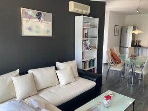 a living room with a white couch and a table at Apartments Nora & Lucija in Baška