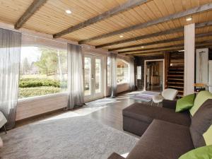 a living room with a couch and a large window at Holiday Home Ateljee by Interhome in Rääkkylä