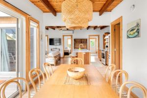 a kitchen and dining room with a wooden table and chairs at Huron Hideaway in Ocean Bay Park