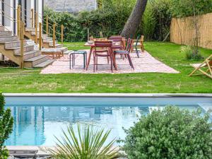 two images of a patio with a table and chairs next to a pool at Villa Villa Azur by Interhome in Carnac