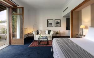 a bedroom with a bed and a living room at Primero Primera in Barcelona