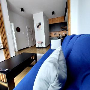 a living room with a blue couch and a table at GOOD PLACE Zator in Zator