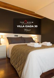 a hotel room with two beds with a sign on the wall at The Queen Luxury Apartments - Villa Giada in Luxembourg