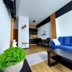 a living room with a blue couch and a table at GOOD PLACE Zator in Zator