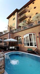 a large swimming pool in front of a building at Hotel La Pigna in Marina di Pietrasanta