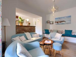a living room with blue couches and a table at Holiday Home Villa Nicolara by Interhome in Buzet +32 photos