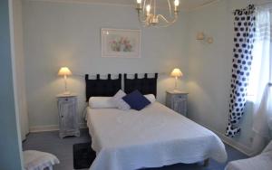 a bedroom with a large bed with two night stands at maison SANSOUN in Léren