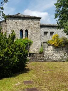 an old stone building with two windows on it at Holiday Home Villa La Chiesa by Interhome in Bosco