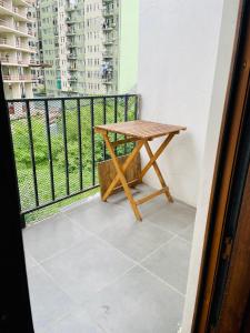 a small wooden table on a balcony with a view at Tamos home 3 in Kakhaberi