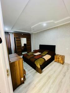 a bedroom with a bed and a wooden floor at Tamos home 3 in Kakhaberi