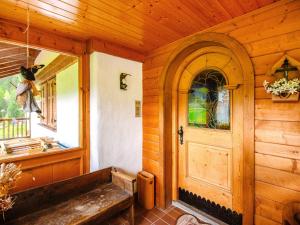 a wooden room with a door and a window at Chalet Cesa Galadriel-3 by Interhome in Penia