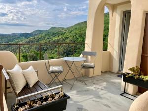a balcony with a table and chairs and a view at Il Contado in Noli