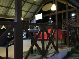 a table and chairs in a building with a table and chairs at Ezime Guesthouse And Pizzeria in Ada