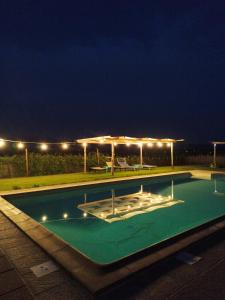 an empty swimming pool at night with lights at La Rugantina in Cortona