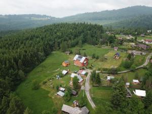 an aerial view of a house on a green field at Agroturystyka Pod Wierchami in Żabnica