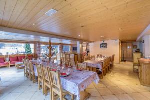 a large dining room with tables and chairs at Rare Chalet 30 Personnes in Morzine
