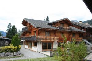 a large wooden house with a lot of windows at Rare Chalet 30 Personnes in Morzine
