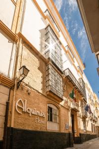 a building with a hotel sign on the side of it at Hotel Alquimia Cadiz in Cádiz