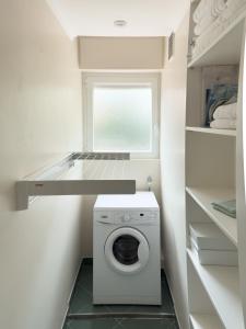 a laundry room with a washing machine and a window at Cosy stay - LA CROISETTE in Cannes