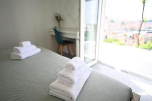 a hotel room with towels on a bed with a window at House La Vista Hvar in Hvar