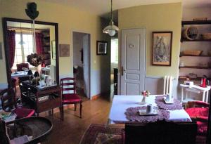 a living room with a table and chairs at La grand' maison in Vorly