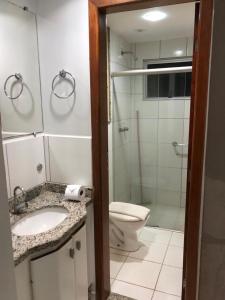 a bathroom with a toilet and a sink and a shower at Golden Dolphin Grand Hotel in Caldas Novas