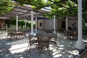 a patio with tables and chairs under a pergola at NACIONAL in Trebinje
