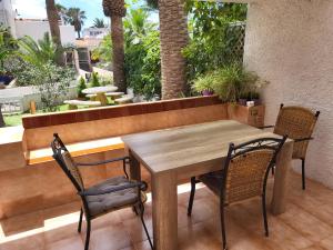 a wooden table and chairs on a patio at Studio with garden in Arona