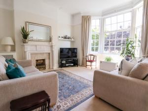 a living room with two couches and a fireplace at Garden Suite in Wallasey