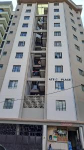 an apartment building with people sitting in the balconies at Attic place South B. in Nairobi