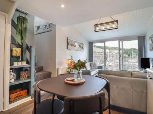 a living room with a table and a couch at Moelwyn 57D South Snowdon Wharf in Porthmadog